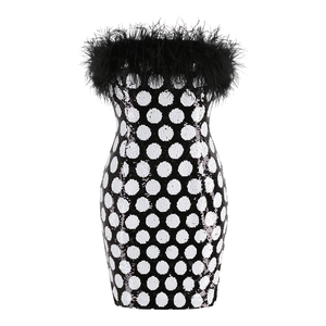Detailed close-up of monochrome polka dot sequins and black ostrich feather trim on top