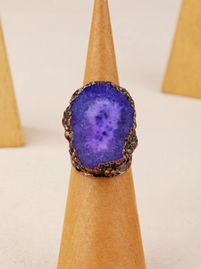 Macro view of purple crystal stone set in an antique bronze irregular ring band