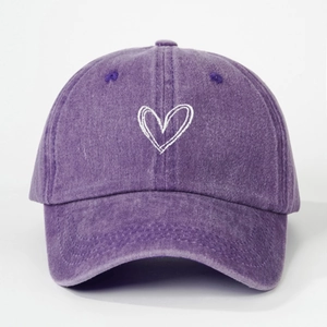 Close-up of heart embroidery on washed cotton purple baseball cap for kids with fabric detail