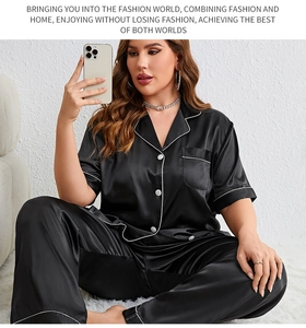 Detail of black satin pajama set with white contrast piping and short sleeve lapel design