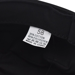 Detail view of cotton-polyester inner sweatband and size label for black PU beret hat