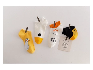 Detailed view of cartoon duck cotton socks hanging on a rope with decorative card