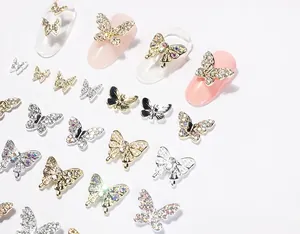 Macro detail of 3D butterfly nail art charms with micro-pave crystals and pearls