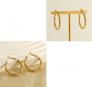 Macro view of gold twisted rope hoop earrings with high-polish finish and latch closure