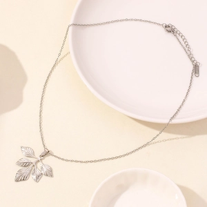 Close-up of silver stainless steel ginkgo leaf pendant with detailed vein texture