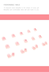 Detailed flat lay of 24pcs pink gradient press-on nails with red heart designs