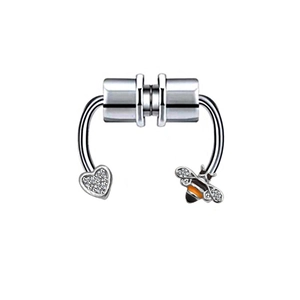 Macro detail of magnetic nose ring with sparkling honey bee and heart shaped charms