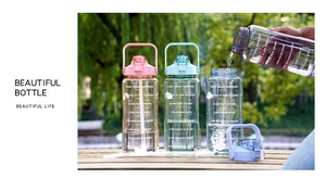 Outdoor close-up of 2L large water bottles with time markers in pink, blue and purple