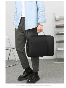 Close-up of a black minimalist business laptop bag with premium texture and zipper detail