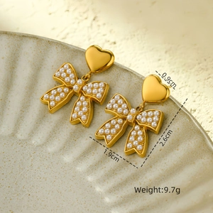 Detailed dimensions of golden heart bow pearl earrings with 9.7g weight and size labels