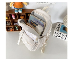Detail of spacious nylon backpack interior holding books and a thermos for students