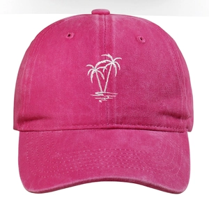 Close-up of white palm tree embroidery on a vintage washed deep pink baseball cap