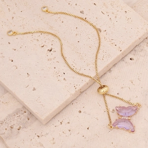 Detail of adjustable 18K gold chain featuring a purple translucent butterfly pendant