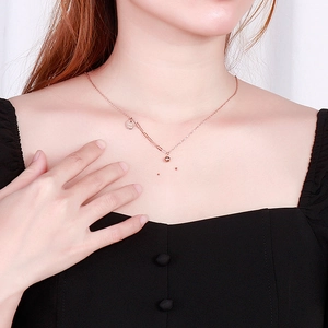Rose gold stainless steel necklace with Good Luck pendant and bead on asymmetric chain