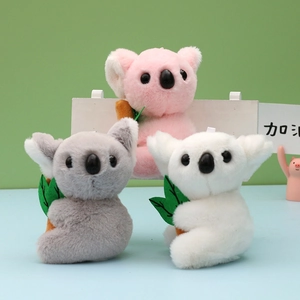 Adorable plush koala keychains in pink, grey, and white holding green branches