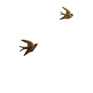 Pair of golden swallow wall decorations in flying pose on a clean white background