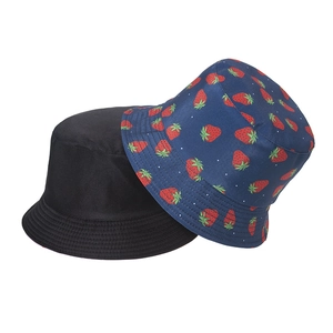 Detail of strawberry embroidery and reinforced stitching on reversible bucket hats