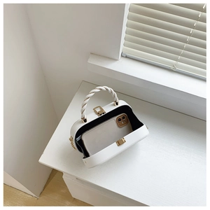 Detail of white rigid box bag showing internal capacity with a smartphone inside