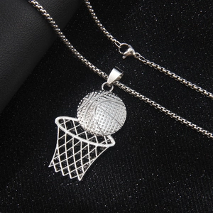 Hip hop silver basketball and hoop pendant necklace on dark textured surface