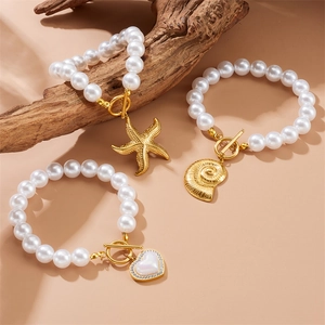 French vintage pearl bracelet set with gold starfish, nautilus shell and heart charms