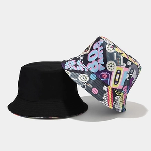 Detail of reversible bucket hat featuring retro 80s icons and vintage cassette tape pattern