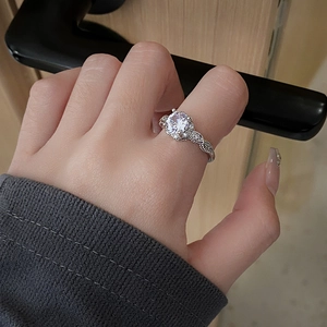 Elegant adjustable silver ring with round zircon and twisted pave band on hand