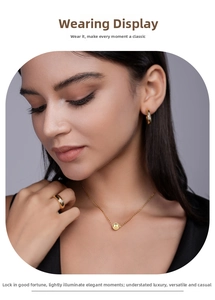Close-up of elegant gold S925 silver necklace, ring and earrings set worn by a model