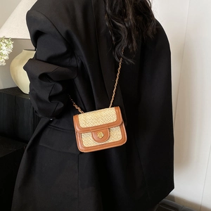 Chic beige woven straw flap crossbody bag with brown leather trim and gold flower buckle