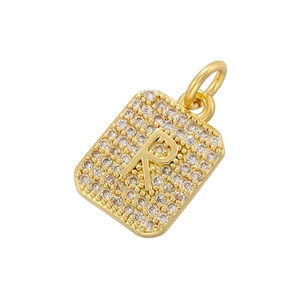 Macro shot of gold square pendant with letter R featuring micro-pave cubic zirconia