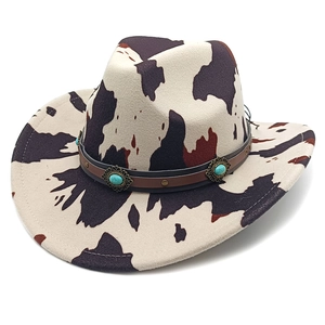 Detail of cow print cowboy hat with turquoise beads on a brown leather band