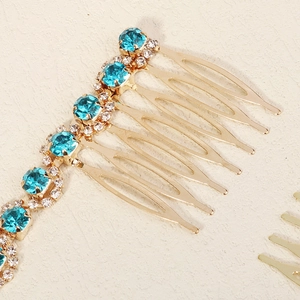 Detail shot of a golden bridal hair comb with elegant blue and clear crystals on top
