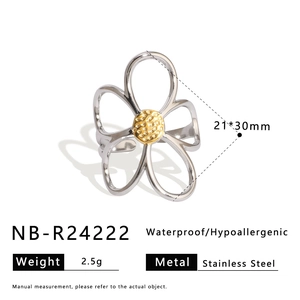 Detail of hollow flower ring in stainless steel with silver petals and golden texture