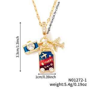 Macro shot of travel-themed necklace featuring enamel camera, suitcase, and plane charms