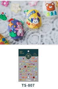 Detail of 5D embossed nail stickers featuring colorful rainbow and rabbit patterns
