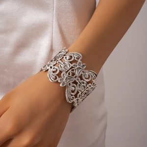 Detailed view of vintage silver hollow flower cuff bracelet with intricate floral patterns