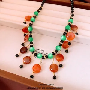 Vintage beaded fringe necklace with green and orange beads and gold-toned accents