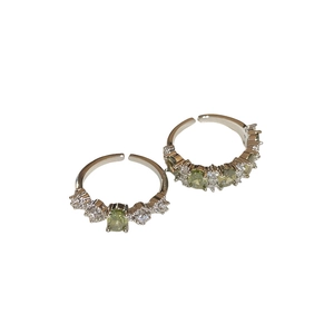 Set of two vintage silver rings with olive green oval stones and white cubic zirconia