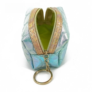 Macro view of iridescent mermaid scale quilted mini coin purse with green fabric lining