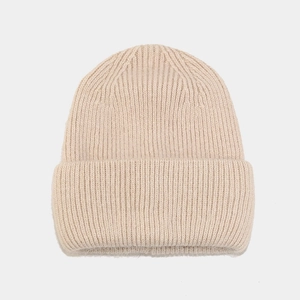 Detail of beige angora rabbit hair beanie showing thick vertical ribbed knit texture