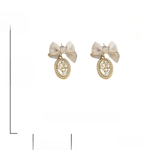 Detail of vintage velvet bow earrings with rhinestones and faux pearls, 925 silver needles