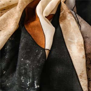 Detail of artistic ink painting pattern on soft linen-feel scarf with elegant drapes