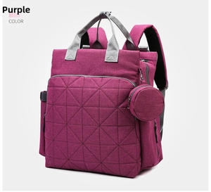Detail of purple waterproof diaper backpack with quilted front pocket and round coin purse