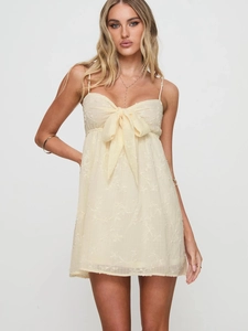Elegant light yellow lace mini dress with spaghetti straps and front bow detail