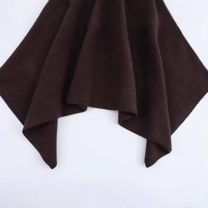 Chic dark brown asymmetric knit poncho coat featuring thick textured fabric and draped hem