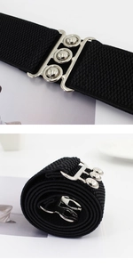 Macro detail of elastic black waist belt and silver interlocking metal buckle mechanism