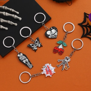 Set of six Halloween keychains featuring skulls, spiders and cherries on orange fabric