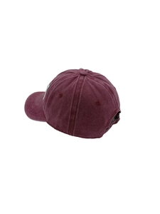 Detail view of burgundy washed cotton baseball cap showing back buckle and 6-panel structure