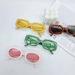Flat lay of vintage square frame sunglasses in yellow, brown, green and pink colors