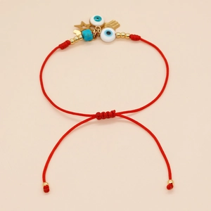 Handmade red braided string bracelet with Evil Eye charms and Hamsa Hand pendant for luck