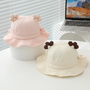 Detail of baby sun bucket hats with cute flower accents and soft waffle cotton texture